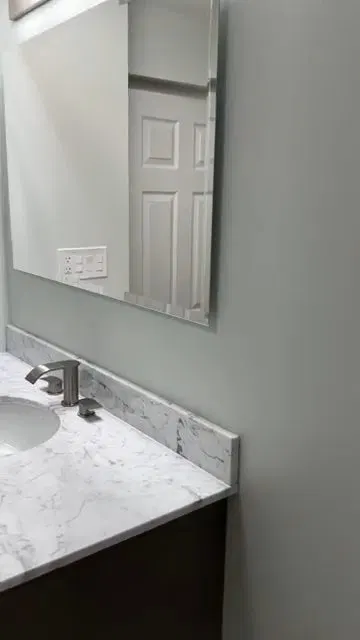 Bathroom plumbing renovation showing drain connection