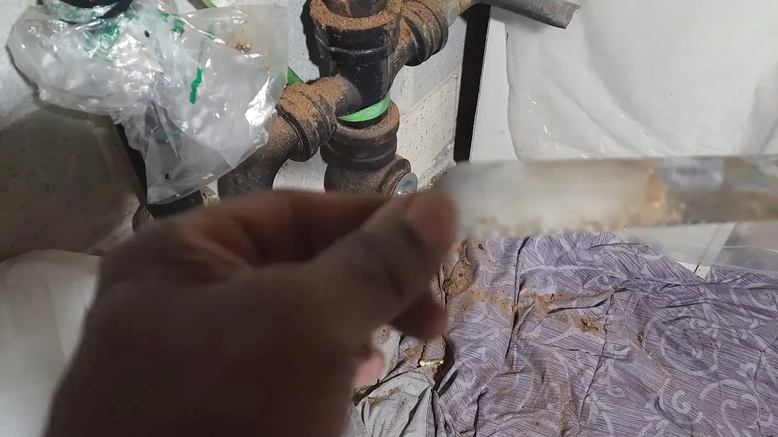 Corroded pipe section used in cast iron pipe replacement