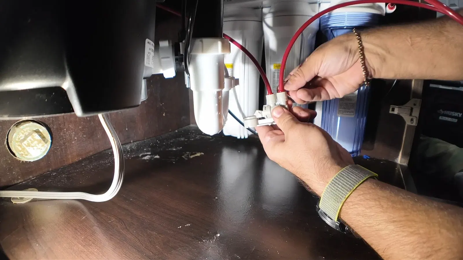 Plumbing service view of drain connection in garbage disposal repair installation