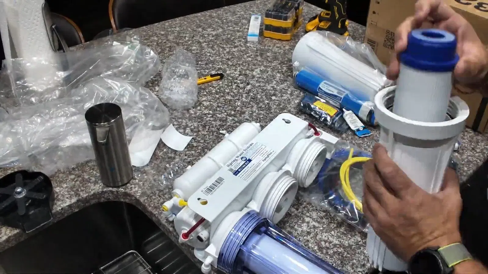 Plumbing service view of filter cartridge area in reverse osmosis installation