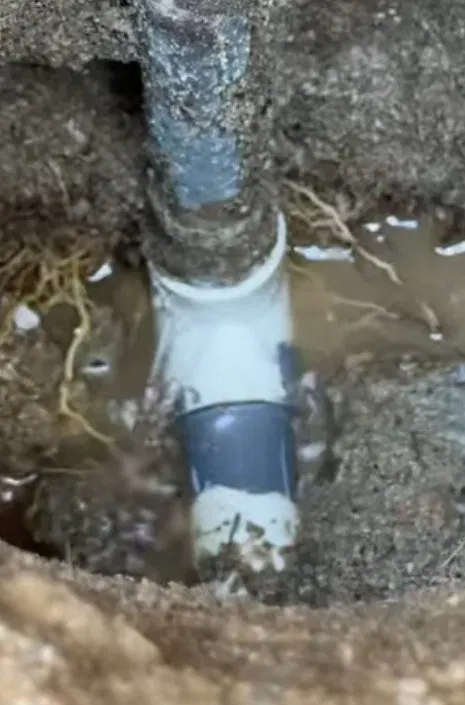 Sewer line repair showing corroded pipe section