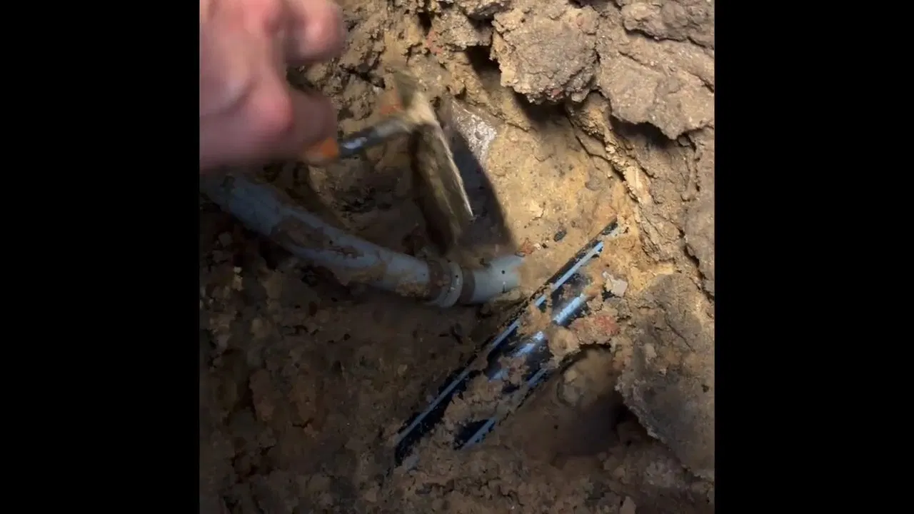 Under slab burst pipe repair showing drain pipe routing