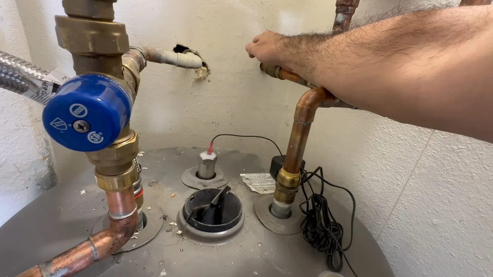 Close view of drain valve for water heater anode rod